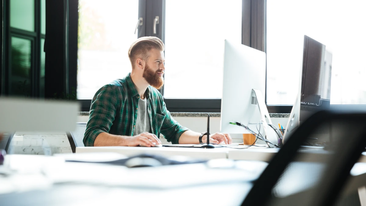 Man on computer in office setting